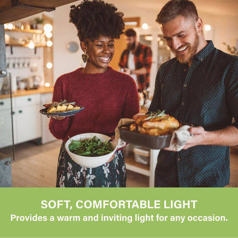 Couple using G25 LED Globe Vanity Light Bulb in kitchen, showcasing soft 2700K light for warm atmosphere. UL Listed, Six Pack.