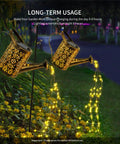 Copper Solar Watering Can Garden Light With Waterfall Effect And 60 LEDs illuminating a flower bed at night.