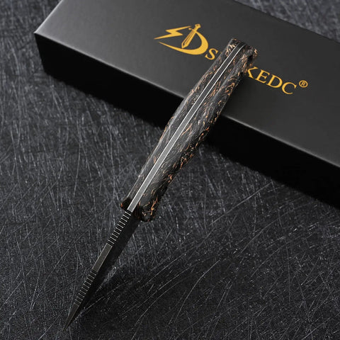 DC53 Steel Fixed Blade Knife With Rugged Shredded Carbon Fiber Handle, top view, against black scratch-patterned surface.