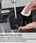 Person cleaning a waterproof digital kitchen scale with 11 pound capacity under running water, showcasing easy clean stainless platform.