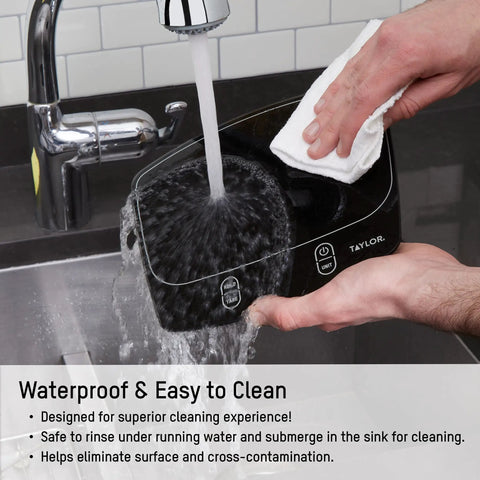 Person cleaning a waterproof digital kitchen scale with 11 pound capacity under running water, showcasing easy clean stainless platform.
