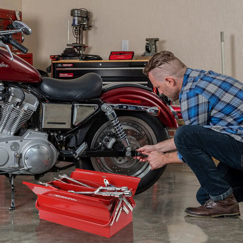 Man using Heavy Duty 18 Inch Cantilever Tool Box With 5 Tray Foldout Organizer Metal Red Storage Case next to motorcycle