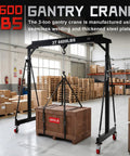 Ridiculously Strong 3 Ton Gantry Crane in warehouse, adjustable height, lifting wooden crate, heavy duty steel construction.