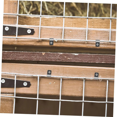 Close-up of 100Pcs Stainless Steel Fence Wire Clips And Heavy Duty Clamps For Securing 4mm Welded Wire To Wood And Vinyl Fences Weather Resistant Quick Install Farm Fencing Must Haves installed on wood.