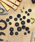 106 Piece Faucet Washer Kit with assorted flat and beveled rubber washers, brass screws, tools on wooden surface for repair and replacement
