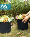 Hands arranging flowers in 12 Pack 5 Gallon Grow Bags With Handles For Easy Move, Heavy Duty 300G Thickened Nonwoven Plant Pots