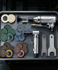 1/4 Inch Angle Air Die Grinder Badass Heavy Duty Tool With 22 Piece Quick Change Sanding Kit on tray with various sanding discs and attachments.