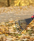 Person using Two Piece Plastic Garden Pitchfork Rake Set With Leaf Grabber Claws for Lawn Cleanup on fallen leaves