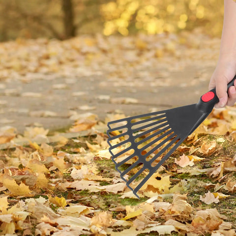Person using Two Piece Plastic Garden Pitchfork Rake Set With Leaf Grabber Claws for Lawn Cleanup on fallen leaves