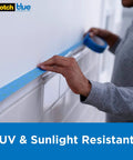 Person applying Sharp Lines Multi Surface Painter Tape For Pro Grade Clean Edges On Walls Trim Tile And Glass One Point Four One Inch By Sixty Yard Six Roll Pack Blue Edge Lock Technology Easy Twenty One Day Removal Indoor And Outdoor Use on white wall
