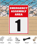 Emergency assembly area sign with number 1, 18x12 inch reflective aluminum, mounted on a fence with pre-drilled holes.