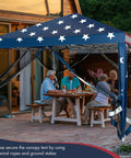 Easy Up 10x10 Pop Up Canopy With Netting And Mesh Sidewalls, Carrying Bag, Adjustable Height, American Flag Outdoor Shade Tent over a patio