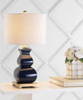 Navy Blue And Gold Ceramic Table Lamp With White Linen Shade on modern table, footed vase design, LED bulb, for living room decor