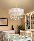 Showstopping Four Lights Drum Crystal Shade Black Chandelier Pendant Light illuminating a dining room space.