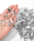 Hand holding 100 Pcs Tiny Dollhouse Hinges 0.7 x 0.51 Inches 180 Degree Miniature Metal Hinges With 400 Screws Silver Durable Iron Hardware