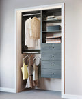 Fully Assembled Grey Closet Organizer Kit With Double Hanging Rods, Shelves, And Drawers As A 54 Inch Corner Unit with clothes and drawers.