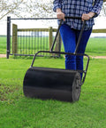 Lawn Roller Heavy Duty For Seedbed Prep, No Fuss Push Or Tow Behind Sod Roller With U Shaped Handle, Water Or Sand Filled Drum, 19.5 Inch Garden Roller For Lawn, Backyard And Garden Care, Black being used on lawn