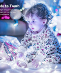 Child playing with Firefly String Lights With Remote, 66 Feet Of 200 LEDs, Indoor Outdoor Plug In, IP65 Waterproof, USB Or Adaptor Powered