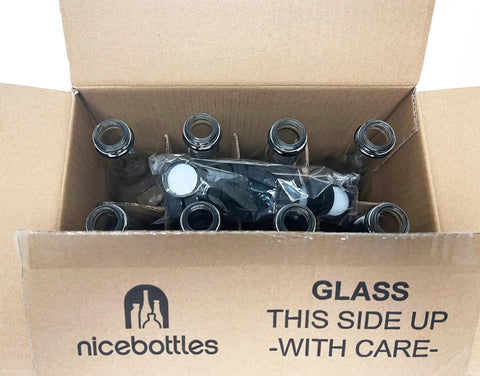 Set Of Twelve Clear Glass Woozy Bottles Packed In A Sturdy Box With Fifteen Black Screw Caps Featuring Food Grade Liners Super Handy For Storing Your Homemade Hot Sauces Oils Dressings Vinegars And Limoncello Each Holds Twelve Point Seven Ounces