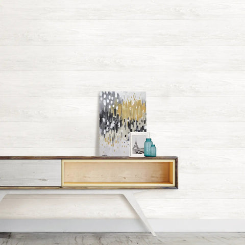 White reclaimed shiplap peel and stick wallpaper in a living room setting with decor for rentals and DIY decor.
