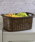 Brown plastic weave laundry basket with easy carry handles on a washer, ventilated design holding colorful folded clothes.