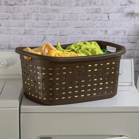 Brown plastic weave laundry basket with easy carry handles on a washer, ventilated design holding colorful folded clothes.