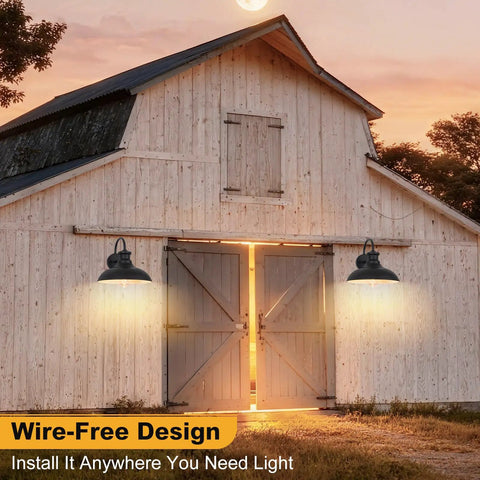 Gooseneck Solar Barn Light 12 Inch Black Outdoor Wall Mount Set installed on barn, illuminating entrance at dusk.