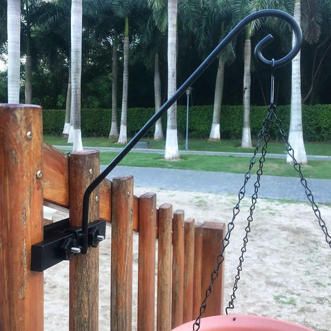 Solid As A Rock Heavy Duty Deck Hooks For Hanging Flower Baskets Bird Feeders And String Lights mounted on wooden railing.