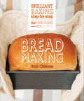 Freshly baked golden loaf in black baking pan held by oven mitts, representing The Step By Step Bread Making Cookbook For Beginner Bakers Foolproof Recipes To Knock Out Crusty Artisan Loaves At Home With Zero Stress Easy Dough Guides That Will Straight Up Level Up Your Baking Skills Today.