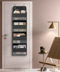 Over The Door Hanging Organizer With Four Large Pockets And Clear Windows, holding toys and books in a room setting.