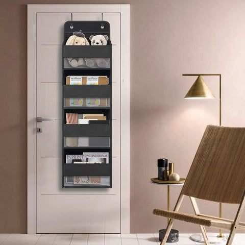 Over The Door Hanging Organizer With Four Large Pockets And Clear Windows, holding toys and books in a room setting.