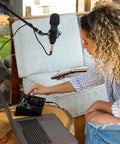 Person using USB-C Audio Interface Kit With 2 In 2 Out, Nova Black Condenser Microphone, Shock Mount, XLR Cable, And HD Headphones