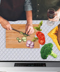 Quilted Stove Top Cover Protector For Glass Ceramic Cooktops as cutting board with vegetables and bread on kitchen counter