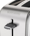 Close-up of stainless steel Two Slice Extra Wide Slot Toaster With Self Centering Guides Seven Shade Settings No Fuss Easy Clean Crumb Tray One Touch Frozen And Cancel Classic Stainless Steel Design For Quick Even Toast Everyday.