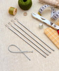 No Fuss Drawstring Threader Tool Flexible Spring Loaded Bodkin with sewing accessories on fabric background