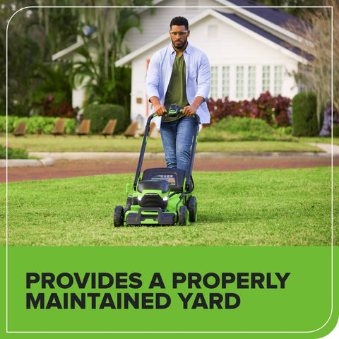 Person using a GreenWorks mower on lawn with the Replacement 21 Inch Mower Blade For 80V And 60V Cordless Lawn Mowers Beefy Black Finish Sharp Cut Easy Install Fits a Wide Range of 21 Inch Deck Mowers For Faster Yard Work installed.