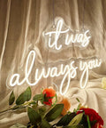 It Was Always You Neon Sign 36 Inch White Neon Night Light Dimmable Wall Decor above fabric backdrop with flowers in view.