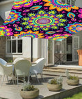 Neon Mandala UV Reactive Sun Shade Sail 6 By 8 Feet blacklight glow canopy installed over patio with chairs and table for outdoor décor.