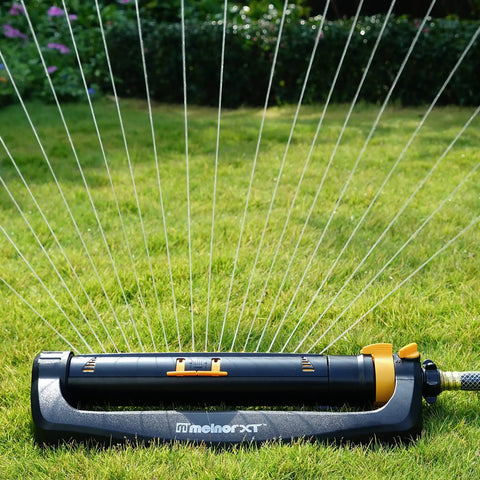 XT Turbo Oscillating Sprinkler For 4500 Sq Ft Quick Connect Bundle on lawn, black and yellow, adjustable spray width and range
