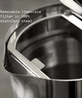 Close-up of stainless steel electric kettle with removable limescale filter, showing double wall design and interior detail.
