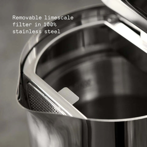 Close-up of stainless steel electric kettle with removable limescale filter, showing double wall design and interior detail.