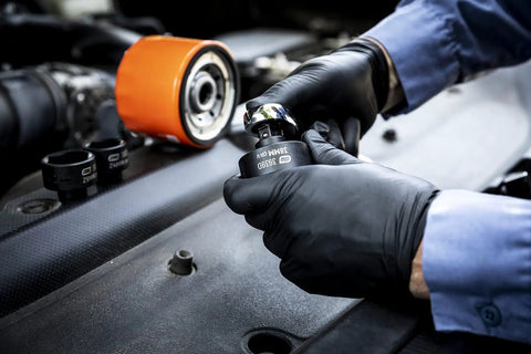 Mechanic using Six Piece Oil Canister Socket Set Service Kit with Black Oxide Coating for automotive repairs on engine part