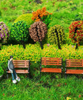 Eight Piece 1 To 24 Scale Mini Park Street Bench Set For Dollhouse And Fairy Garden Brown Tiny Benches against lush foliage