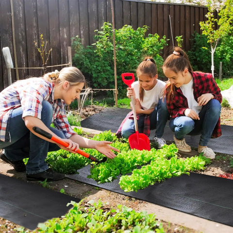 Heavy Duty Weed Barrier Fabric 3.2oz Landscape Material for Garden Beds and Driveways in use with people gardening.