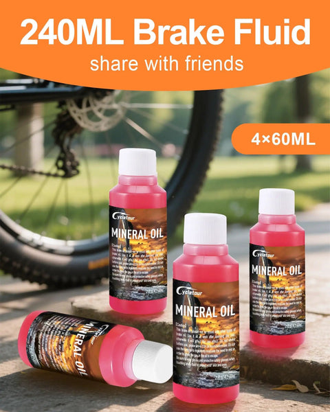 Road Ready All In One Brake Bleed Kit For Hydraulic Disc Brakes Compatible With Shimano TEKTRO And TRP Includes 240 Ml Mineral Oil Fluid In Four 60 Ml Bottles Clear Funnel And Simple Step By Step Instructions, showing four mineral oil bottles near a bike wheel.