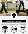 Two people transporting a 125 Qt Gray Party Bar Wheeled Cooler with Ultratherm Insulation, removable lid, and locking casters.