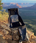 Chillin Chair Ultra Lightweight Foldable Portable Outdoor Seat in scenic landscape setting with carry bag and mug.