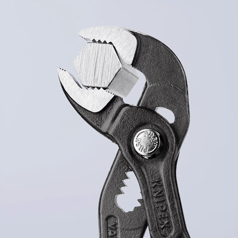 Cobra Water Pump Pliers 6 Inch With Self Locking Teeth And Pinch Guard For Safe Grip holding a hex nut, close-up view.