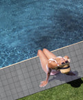 3 By 10 Ft Drainage Pool Floor Mats Non Slip PVC Splash Matting With Mesh Hollow Design next to a swimming pool.