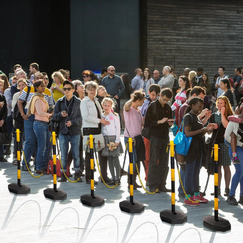 Crowd managed with Six Pack 34 Inch Parking Cone Delineators Stanchion Set with Base and Chain.